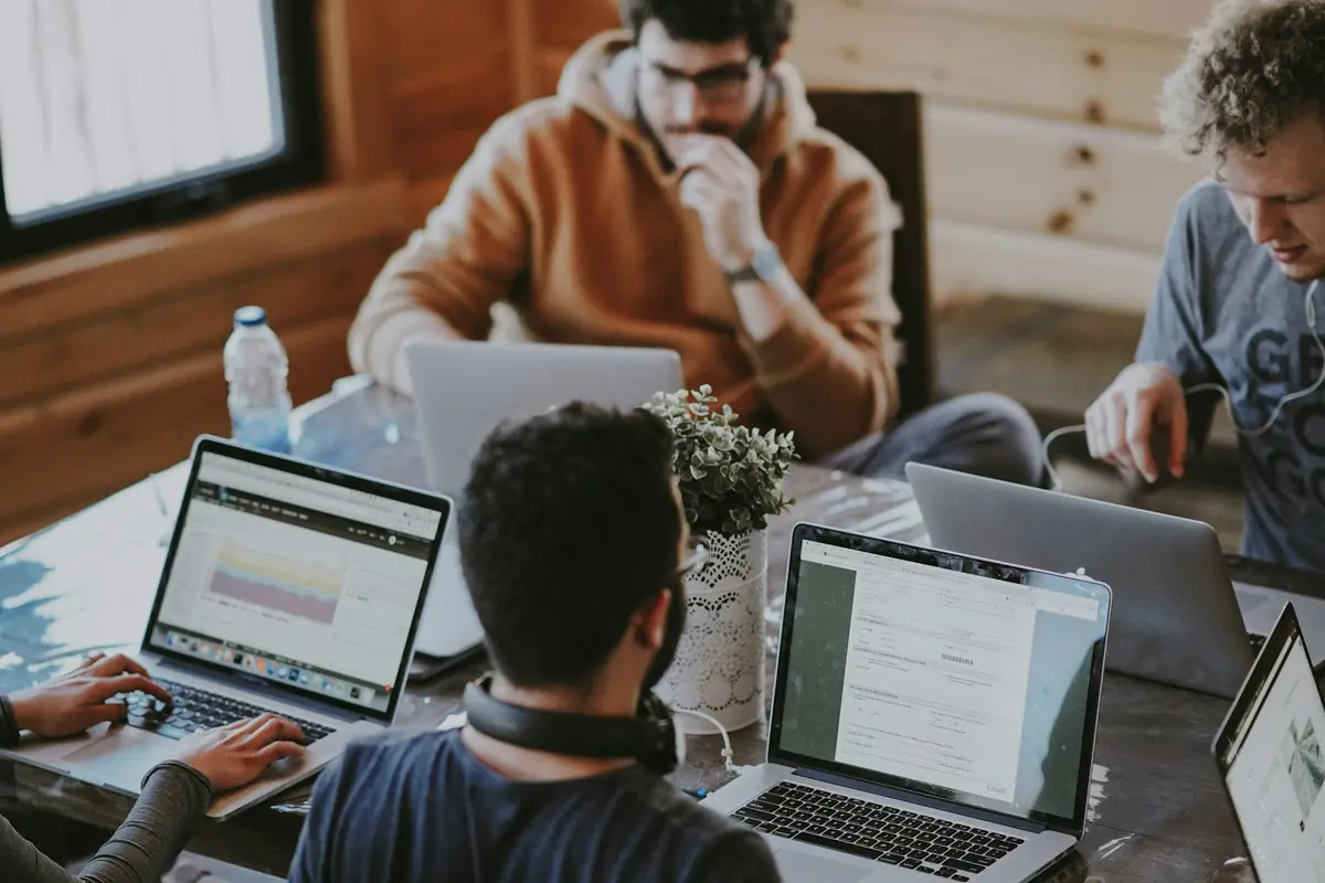 People working together at laptops in a shared office